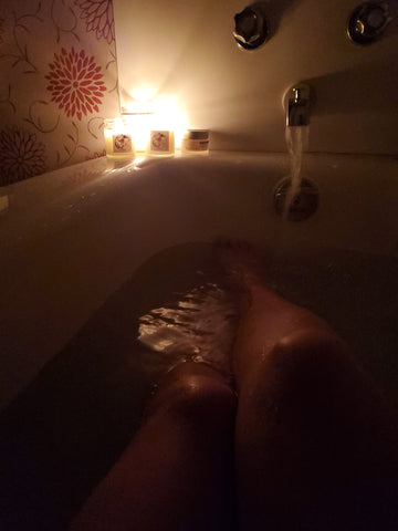 woman enjoying candlelit ritual bath