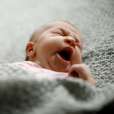 a newborn yawning