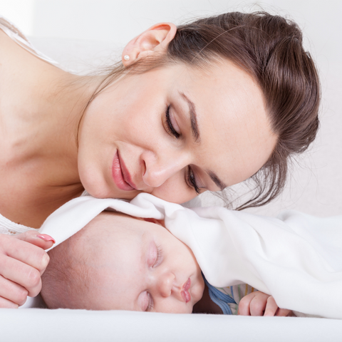 a mom watching her baby sleeping