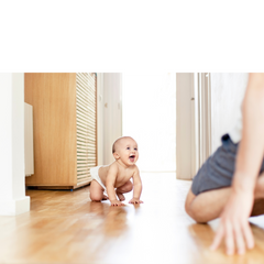 a baby crawling to their father