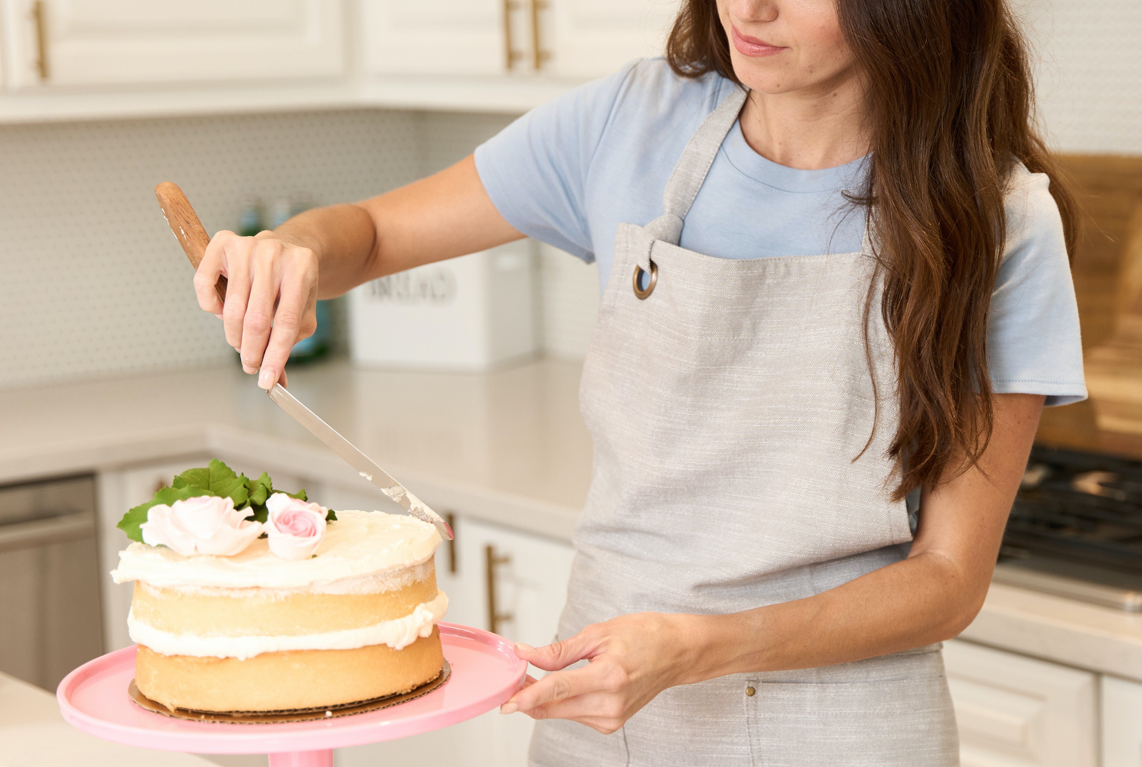 Woman Frosting A Cake
