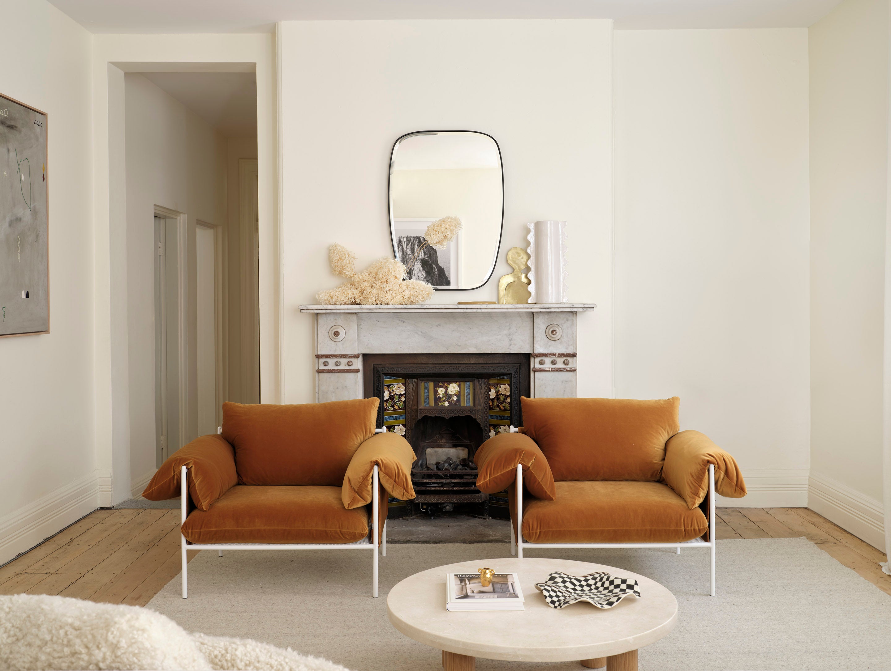 Sarah Ellison's Three Rooms apartment, featuring our Mabel Mirror and the Alva Velvet Armchairs