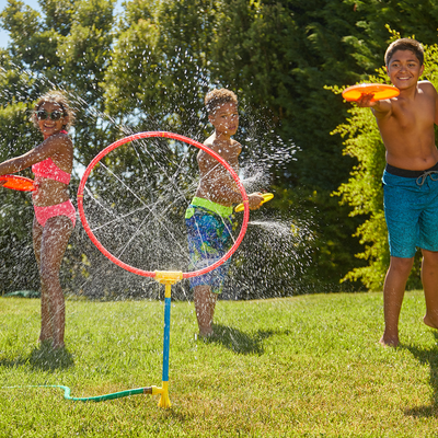 Children are enjoying themselves with Wham-O Giggle 'n Splash Spin Cycle in the garden