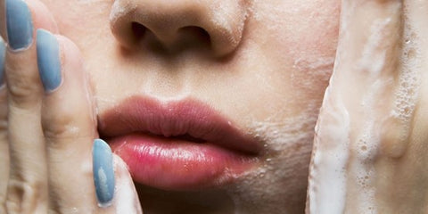 Closeup photo of woman with face wash suds