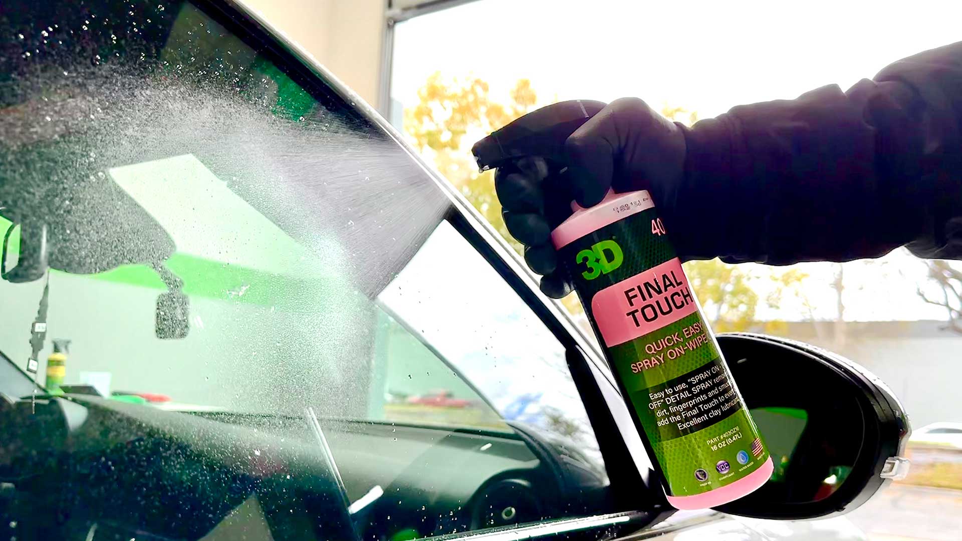 spraying final touch on glass car window