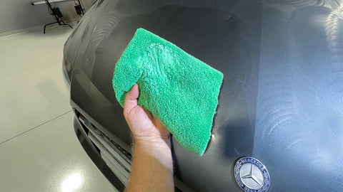 cleaning car with microfiber towel 