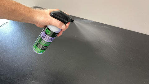spraying table with cleaner 