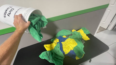 dumping microfiber towels onto a table 