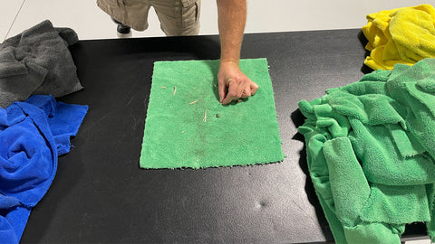 picking dirt off a microfiber towel by hand