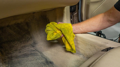 blotting up cleaner from the car floor