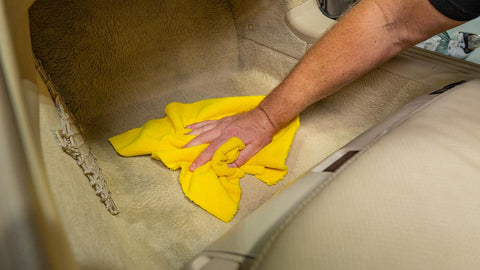 drying cleaner from car carpet with a microfiber towel
