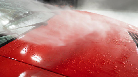 spraying water onto car 