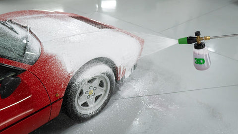 Cleaning car using active foam. Man washing his car on self car