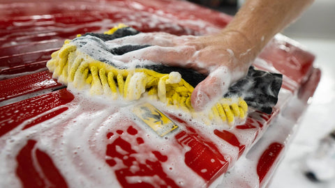 washing sudsy car by hand 