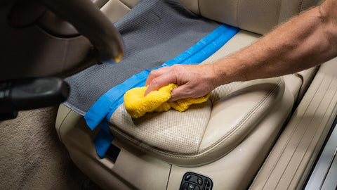 removing access cleaner from car seat with towel 