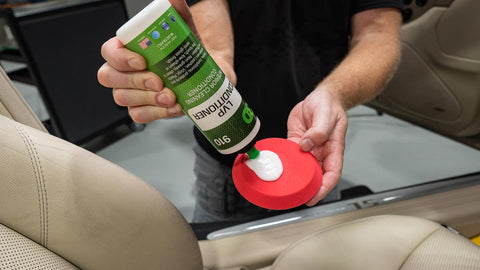 applying leather conditioner to a sponge 