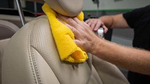 wiping leather car seat clean 