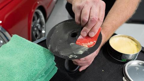 applying wax to a buffing pad