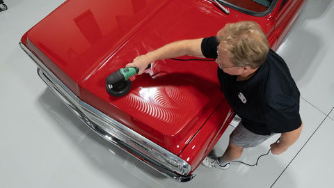 waxing a car with a rotary polisher 