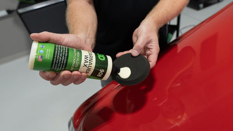 squeezing wax form a bottle onto a sponge 