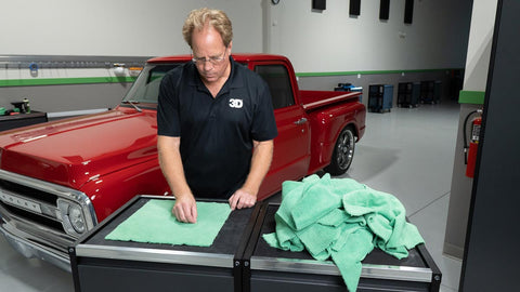 cleaning a microfiber towel with fingers 