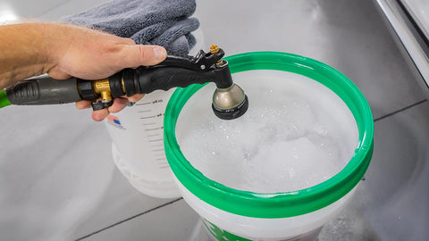 Spraying water into bucket