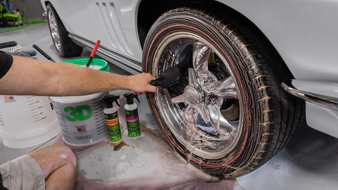 scrubbing tire rims with soap and a scrub brush