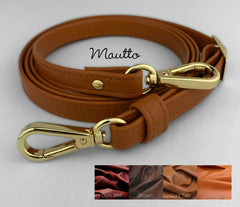 Leather purse strap in fall leather colors, including deep red, earthy dark tan, brown and orange.