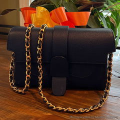 Black satchel bag with gold chain and leather woven strap by Mautto.