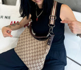 Photo of a Gucci purse with a Mautto accessory strap attached.