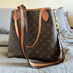 Accessory interchangeable handbag strap on Louis Vuitton bag.