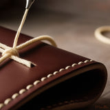 A piece of leather being stitched.