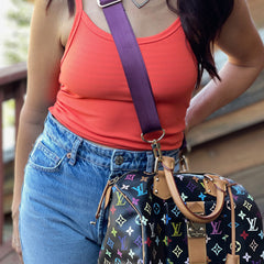 Interchangeable handbag strap on LV bag, worn across the body.