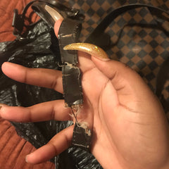 Photo of a broken leather strap that is no longer usable.