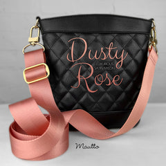 Dusty Rose Gold strap for the Summer Season, attached to a black purse.