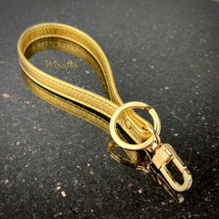 Glamorous gold wrist strap key leash.