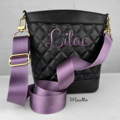 Vibrant purple purse strap on black purse.