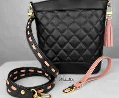 Photo of black handbag with accessory strap, wristlet and leather tassel.