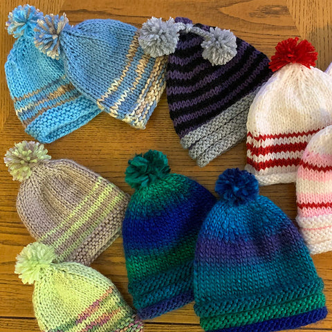 Photo of hand-knitted beanie caps for babies.