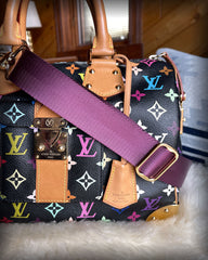 Regal purple accessory strap attached to a handbag.
