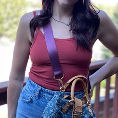 Photo of woman wearing regal purple strap on contrasting attire.