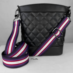 Multi-color purse strap with purple, violet, lavender, cranberry red and white colors. Shown attached to a black purse.