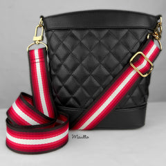 Multi-color purse strap with red, crimson/scarlet, rose pink, and white colors. Shown attached to a black purse.