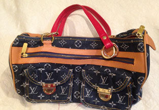 Denim LV bag with red accent straps.