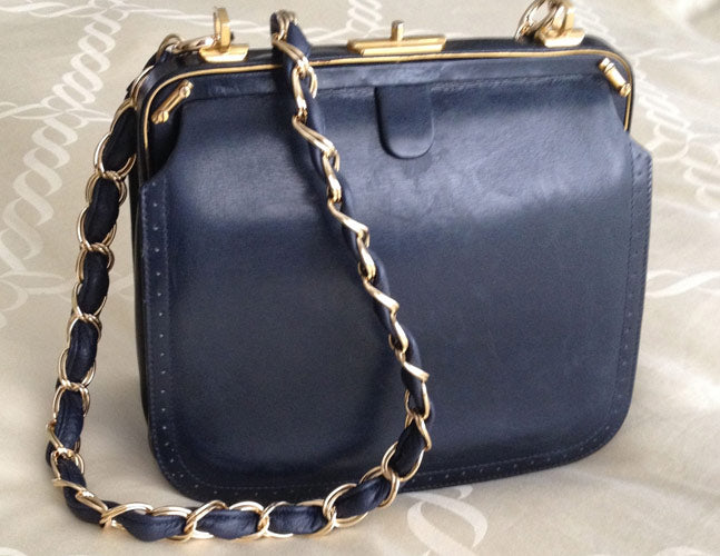 French clutch with chain and leather weave strap.