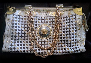 Broken straps on vintage Versace bag replaced with leather weaved through chain straps.