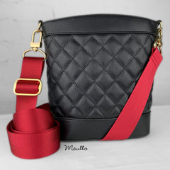Photo of black purse with red strap.