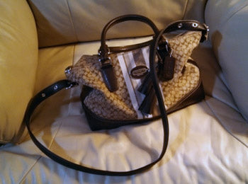 Coach handbag with longer shoulder strap.