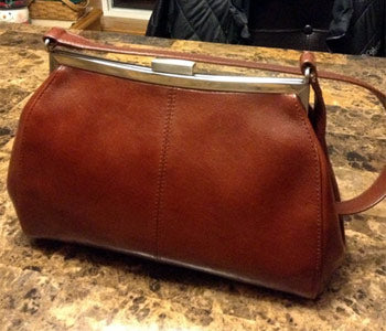 Converting a purse into a crossbody bag.
