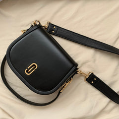 Comfortable wide leather cross body strap on black purse.